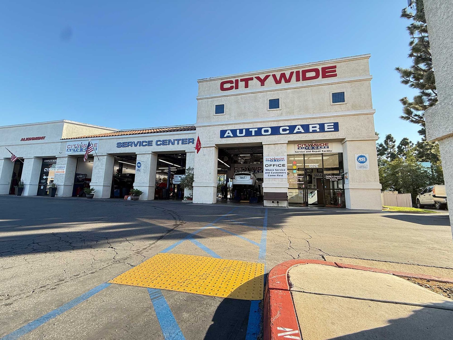 Citywide Auto Care building with service bays, bright sunny day.