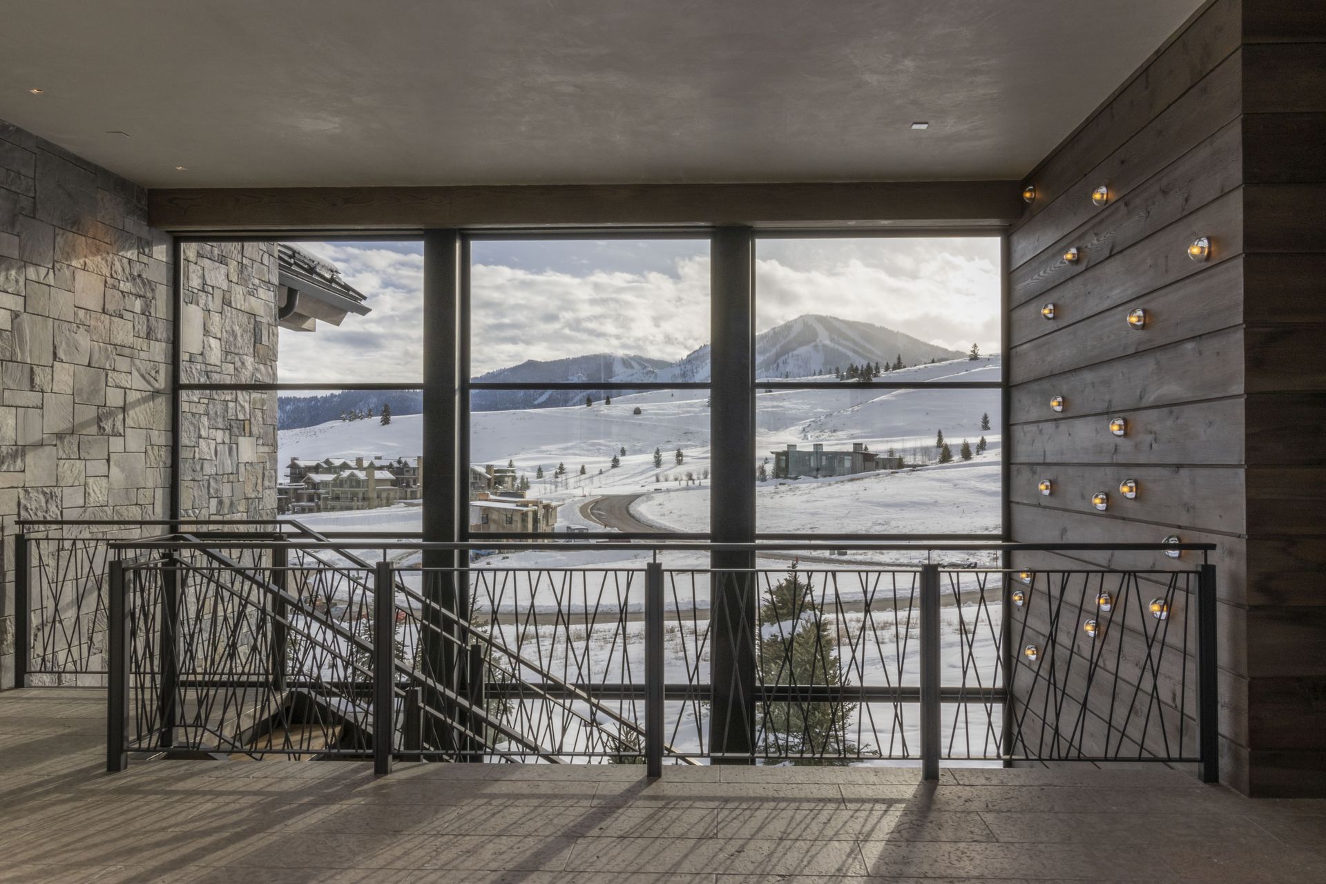 A large window with a view of a snowy mountain range