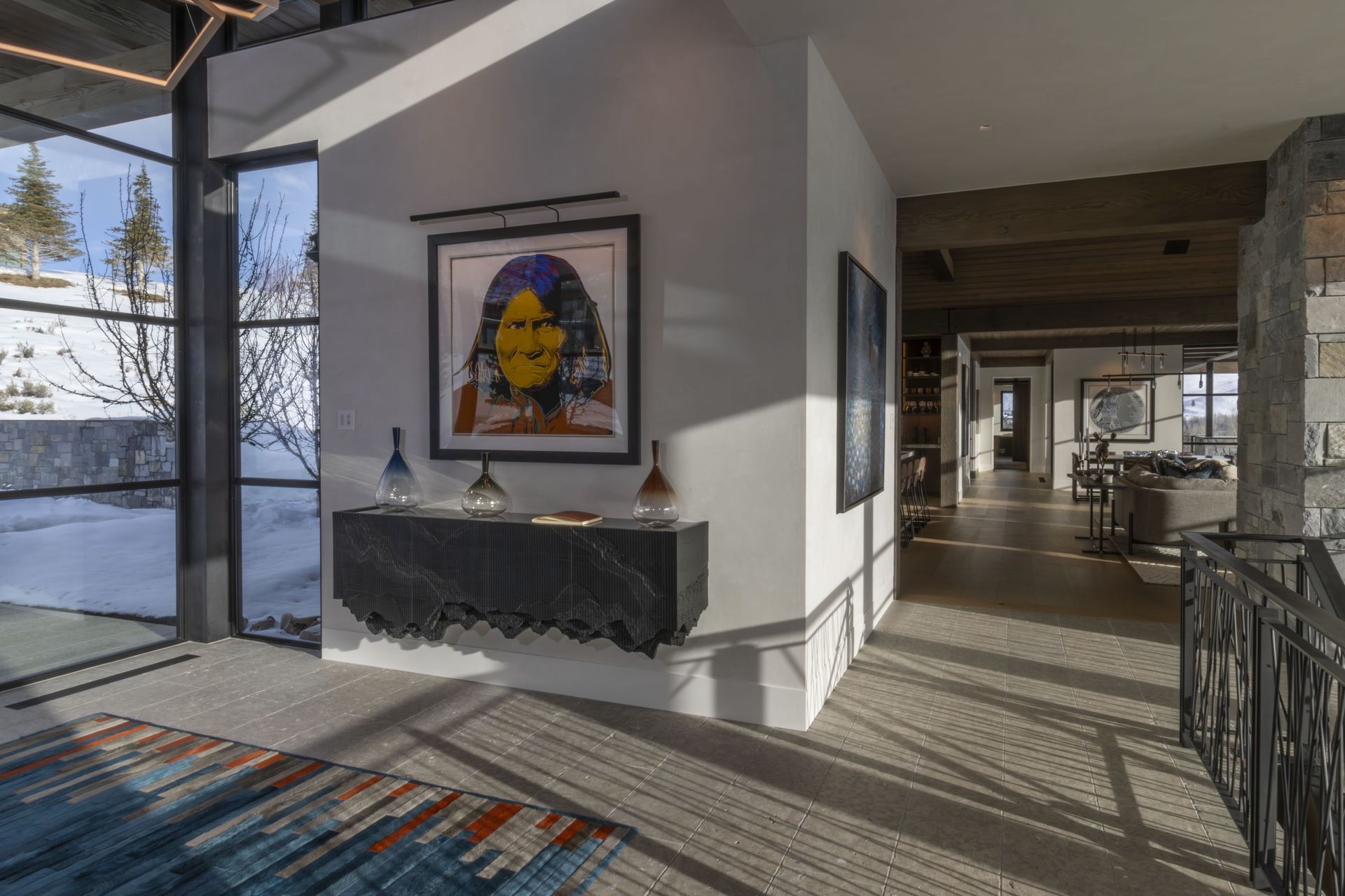 A hallway with a table and a painting on the wall
