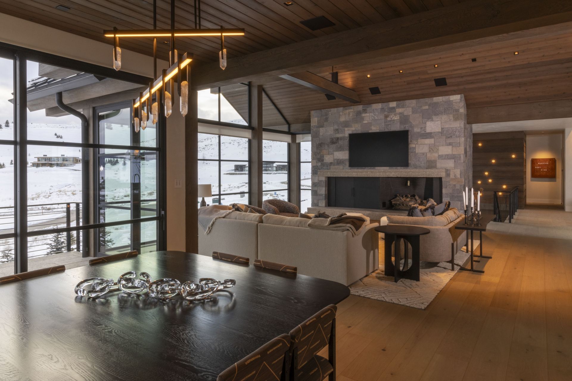 A large living room with a fireplace and a dining table