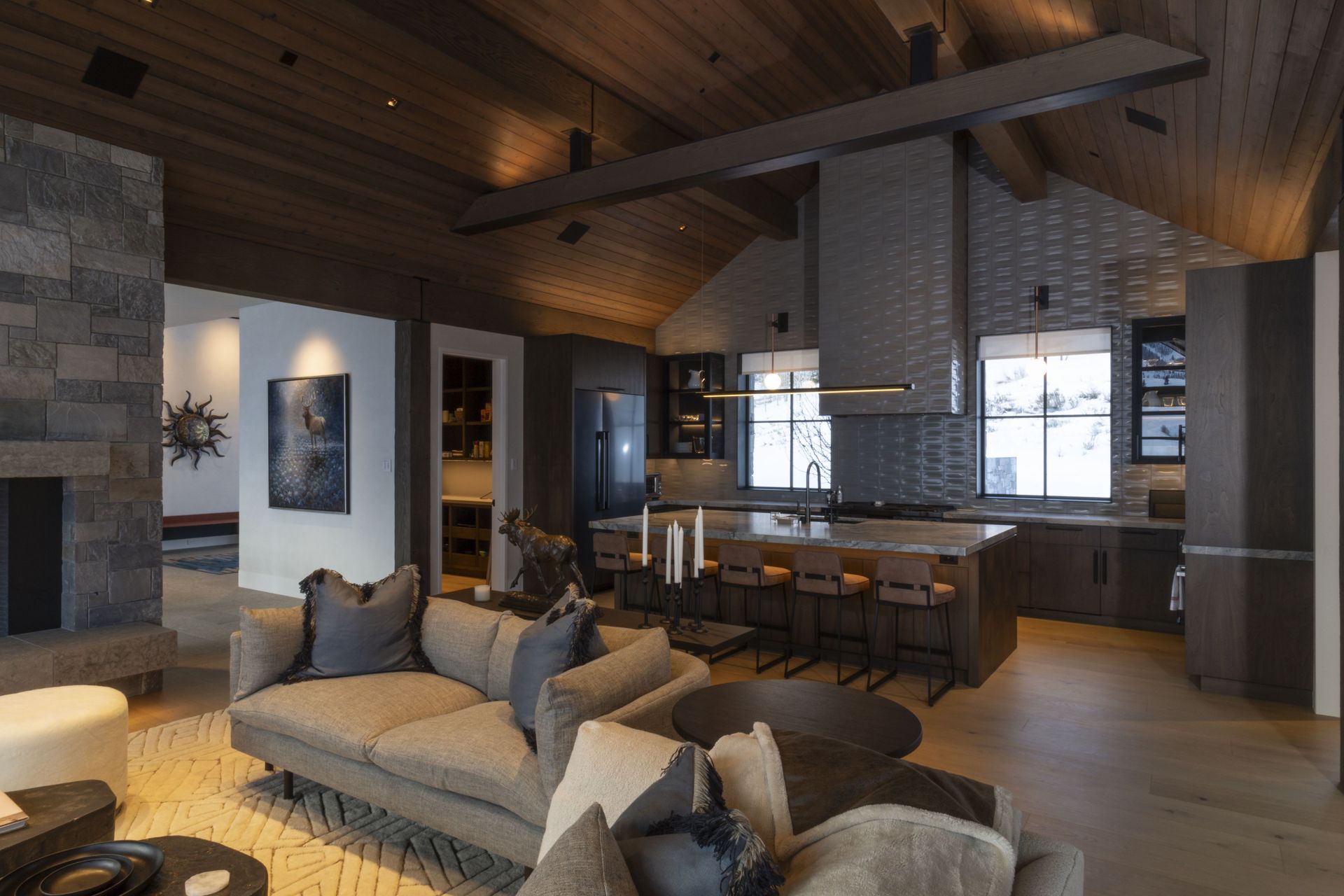 A living room with a couch and a kitchen in the background