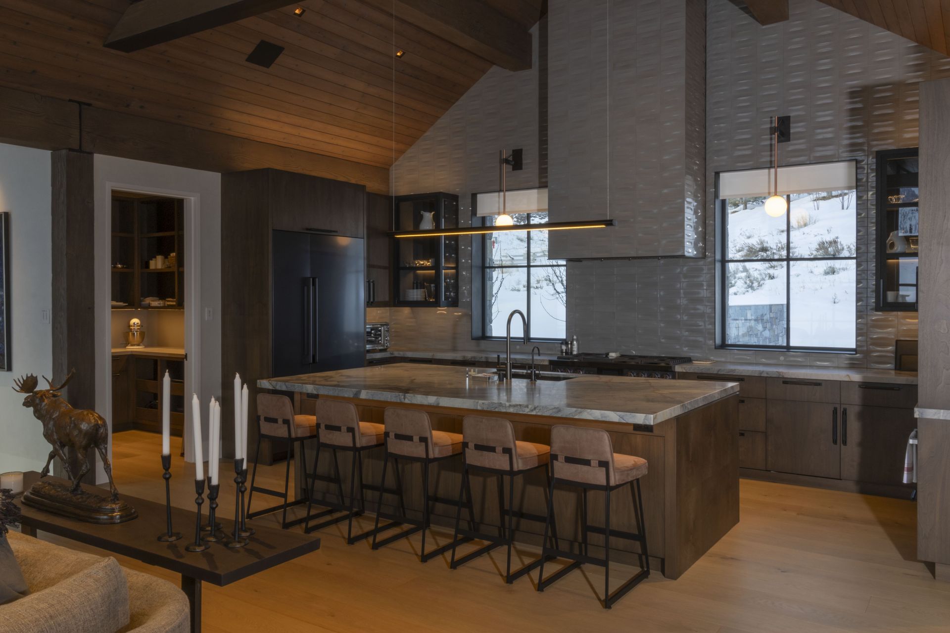 A kitchen with a large island and stools