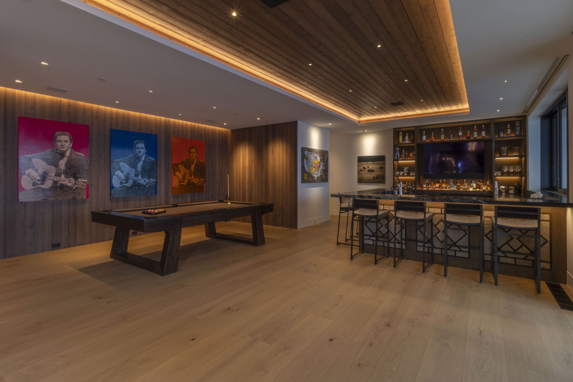 A game room with a pool table and a bar