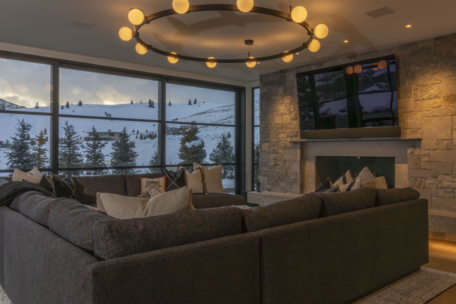 A living room with a large sectional couch and a fireplace