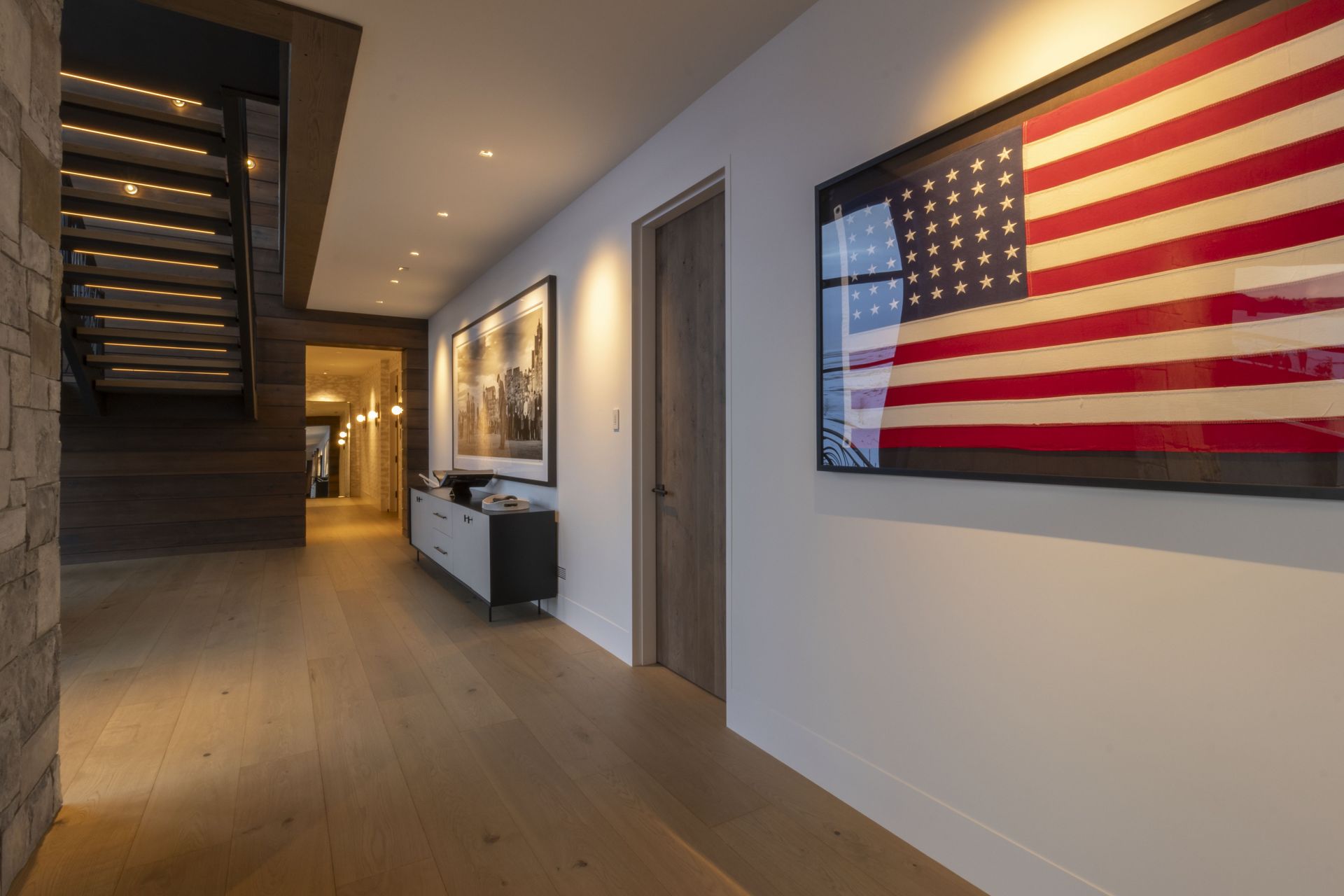 A hallway with a large american flag on the wall