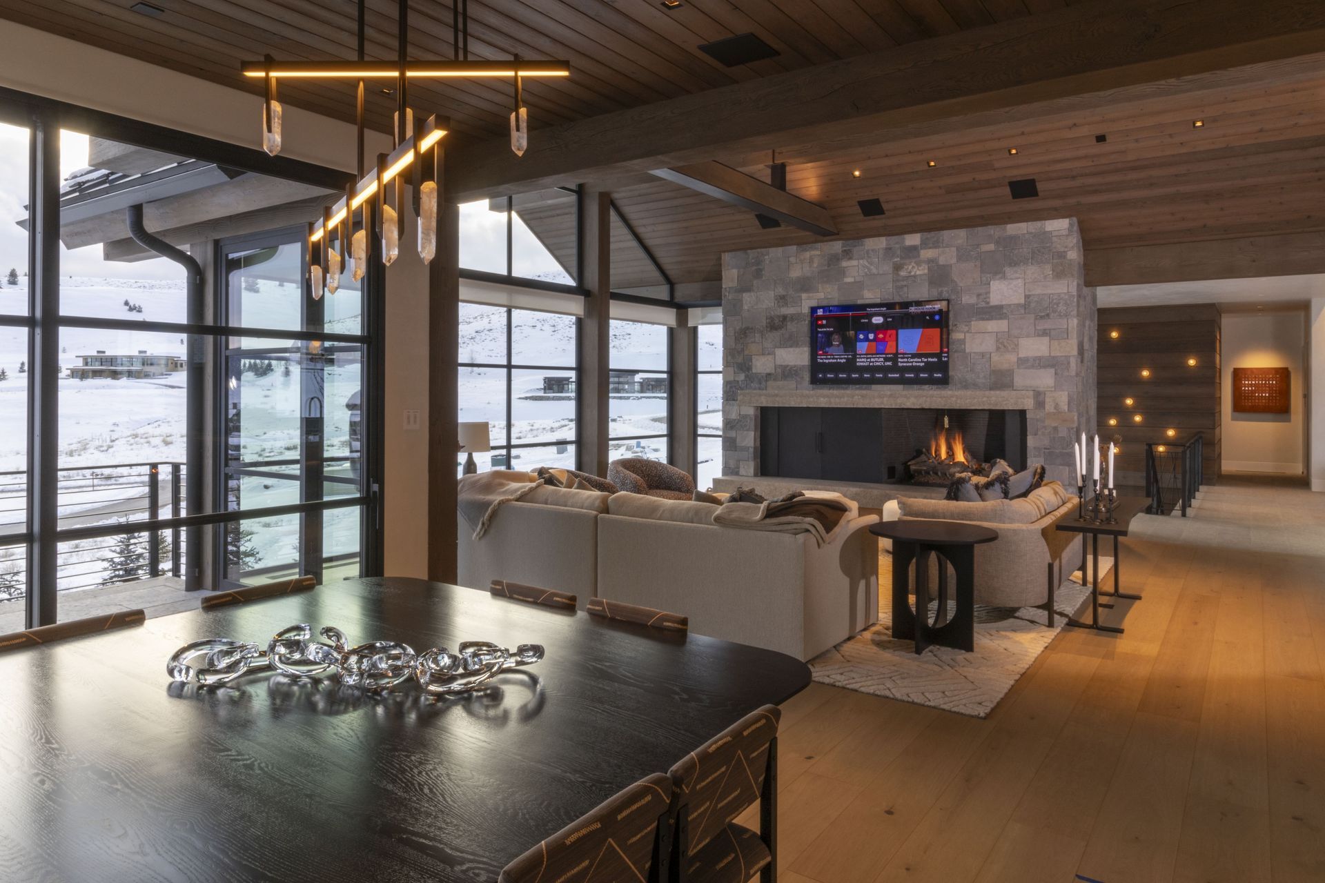 A living room with a fireplace, couch, table and television