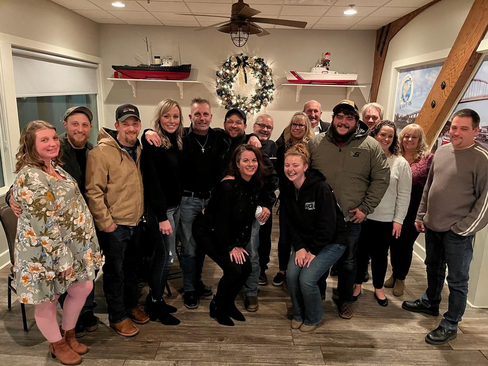 A group of people are posing for a picture in a room.