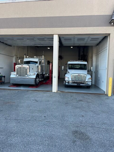 Two Semis Parked in a garage