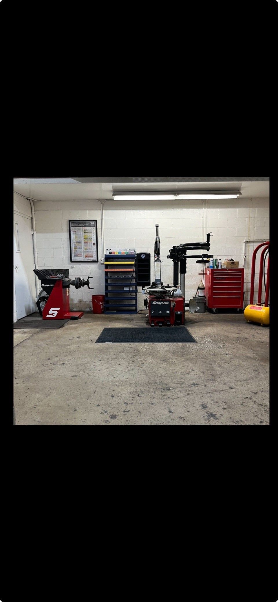 A garage with a lot of tools and equipment in it.