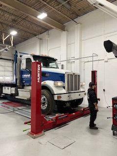 a truck is sitting on a lift in a garage