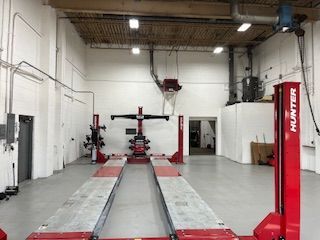 a garage with a red hunter lift in the middle