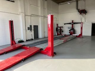 a garage with a lot of red lifts in it