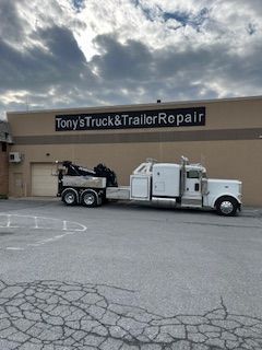 a tow truck is parked in front of a building