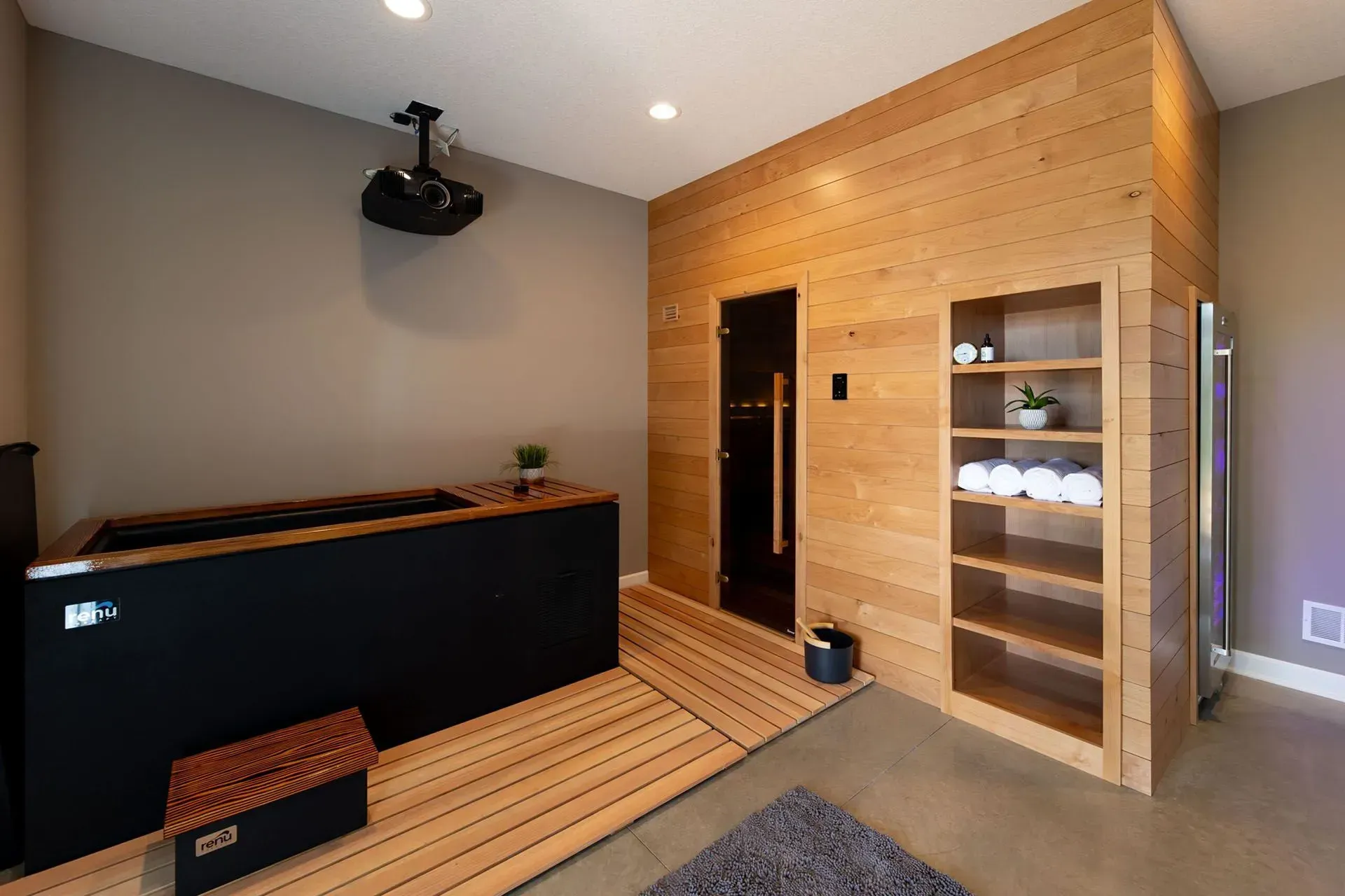 Relaxation room with infrared sauna, cold plunge tub, and storage.