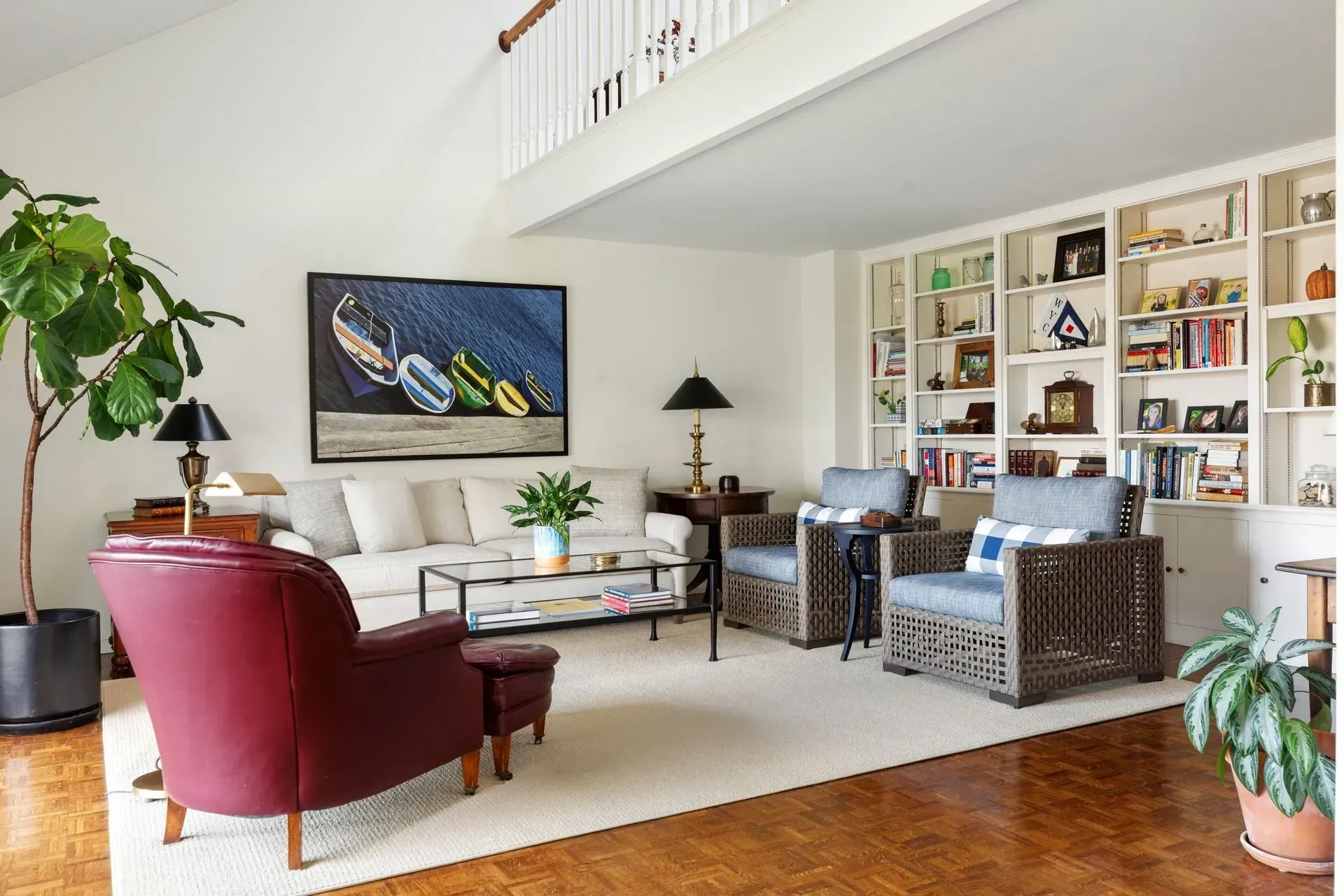 Living room with a sofa, armchairs, and built-in bookshelves.