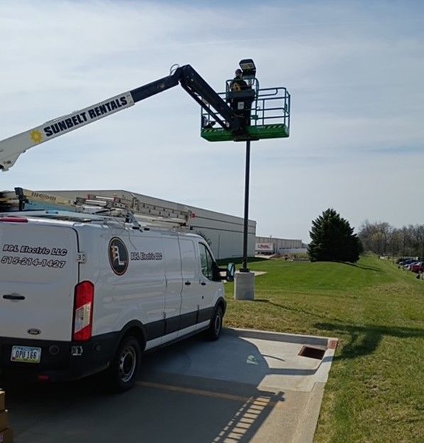 A white van is parked next to a crane that says Sunbelt Rentals