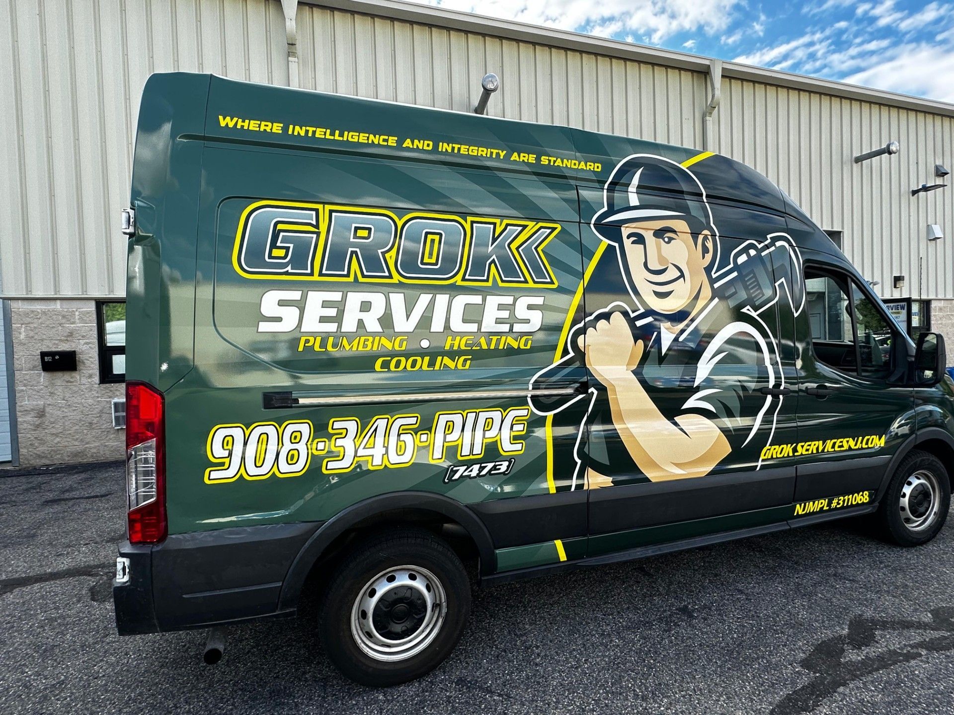 Green Grok Services van with a plumber graphic; contact info on side panel.