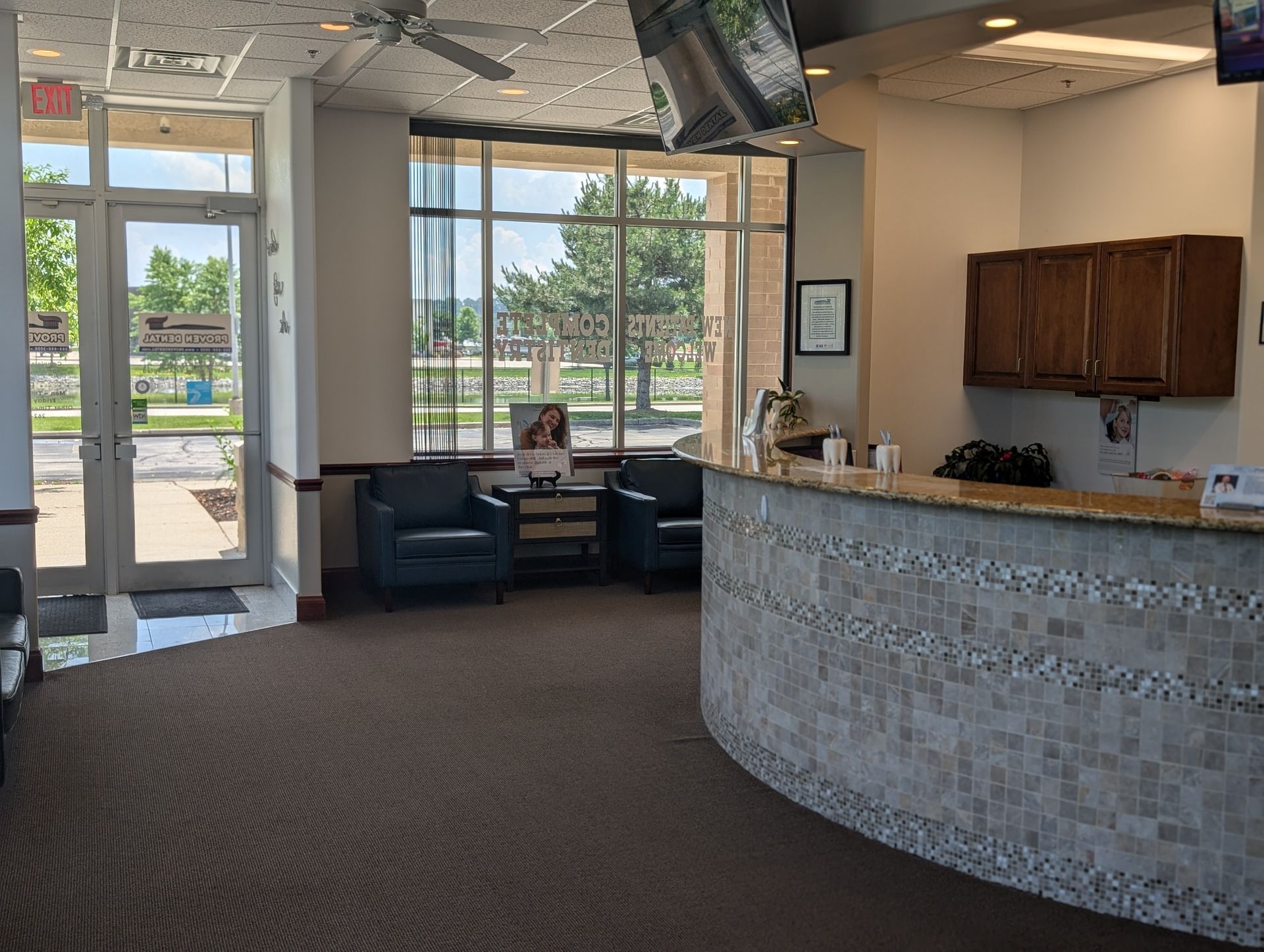 A waiting room with a curved counter and chairs.