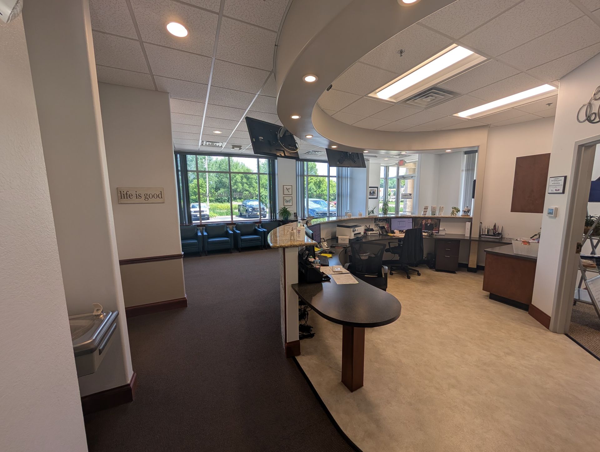 A dental office with a reception desk and a waiting area.