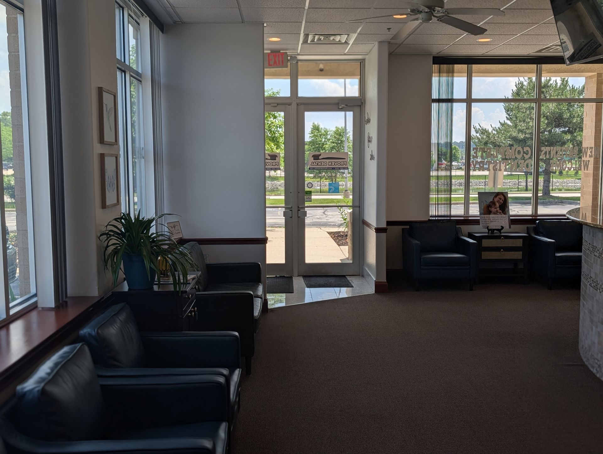A waiting room with chairs and a sign that says dental office on it