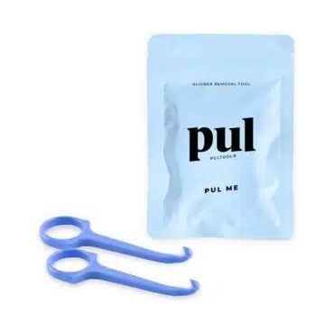 A pair of blue scissors next to a bag that says pul on it.