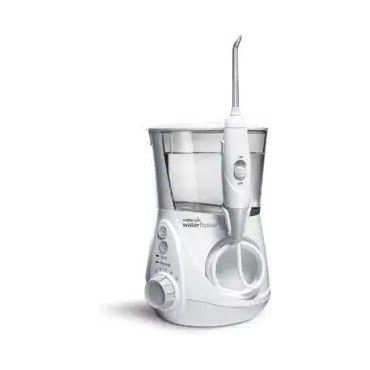 A water flosser is sitting on a white surface.