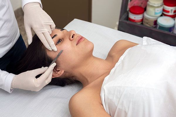 A woman is getting a facial treatment at a spa.