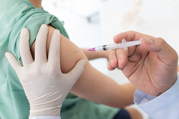 A person is getting an injection in their arm.