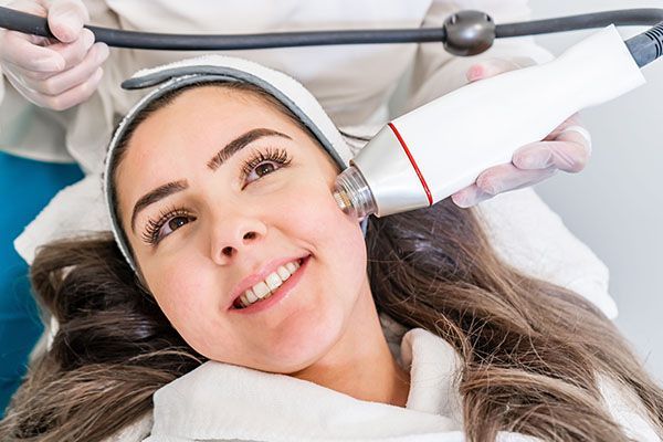A woman is getting a facial treatment at a beauty salon.