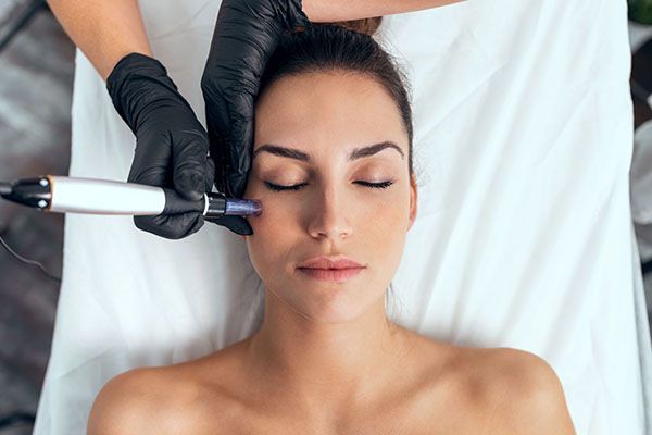 A woman is getting a facial treatment at a beauty salon.