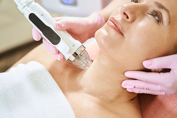 A woman is getting a facial treatment at a beauty salon.