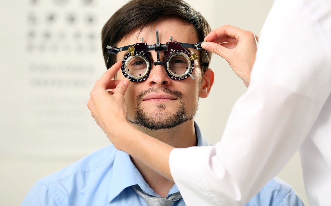 A man is getting his eyes checked by an ophthalmologist.