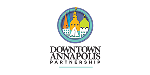 A logo for downtown annapolis partnership with a sailboat in the middle