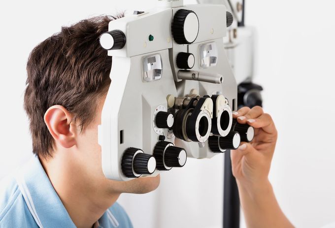 A man is getting his eyes examined by an ophthalmologist.