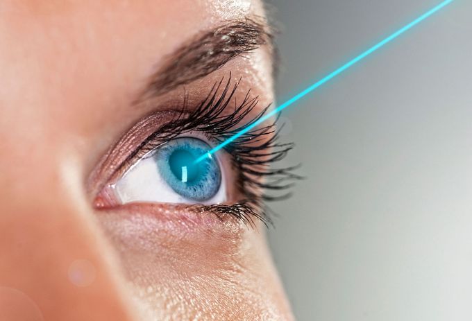 A woman is getting a laser treatment on her eye.