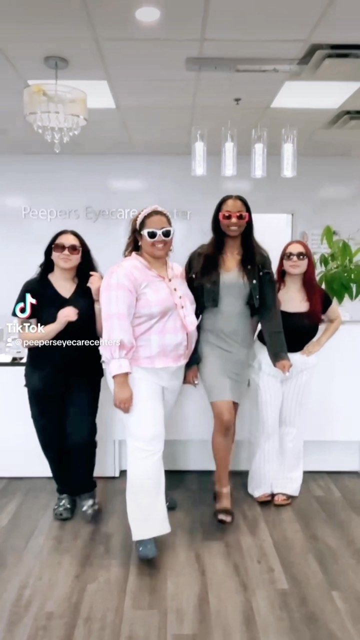 A group of women are standing next to each other in a room.