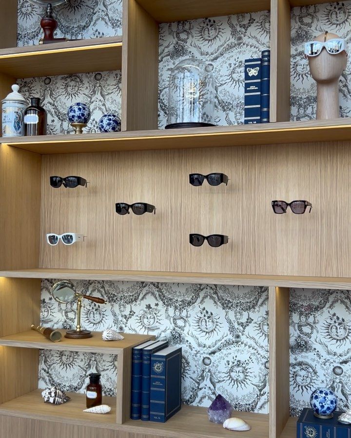 A shelf with sunglasses and books on it