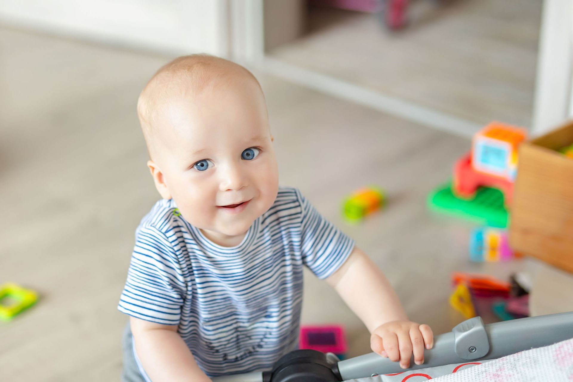 Baby boy playing with toys at nursery