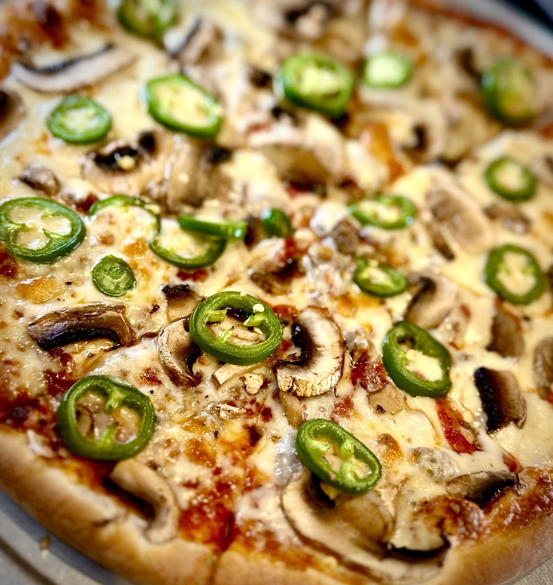 A pizza with mushrooms and green peppers on it
