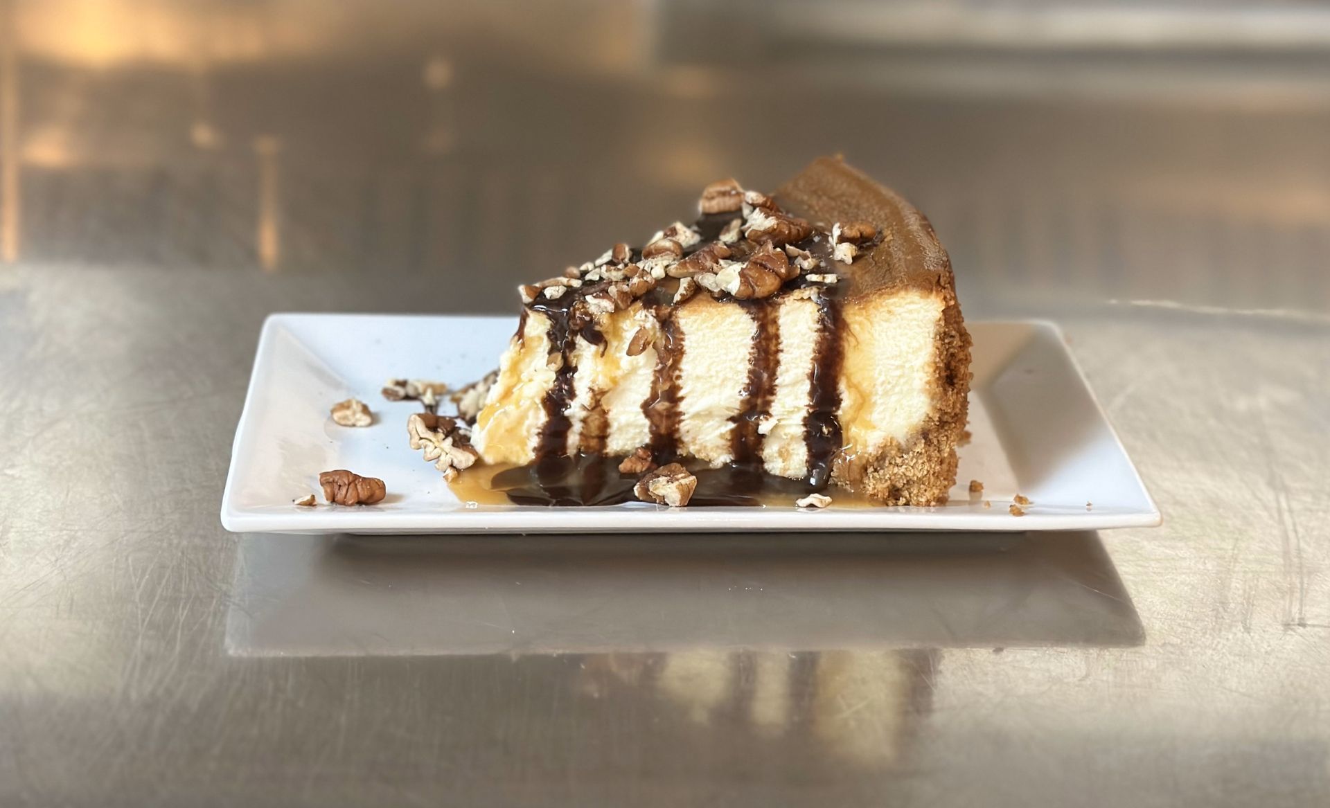 A slice of cheesecake on a white plate on a table