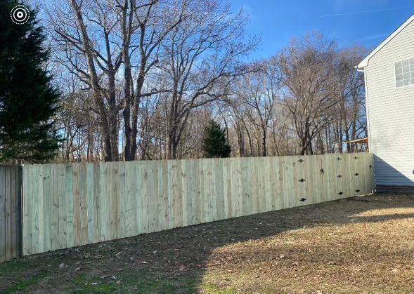 a wooden fence in the backyard of a house