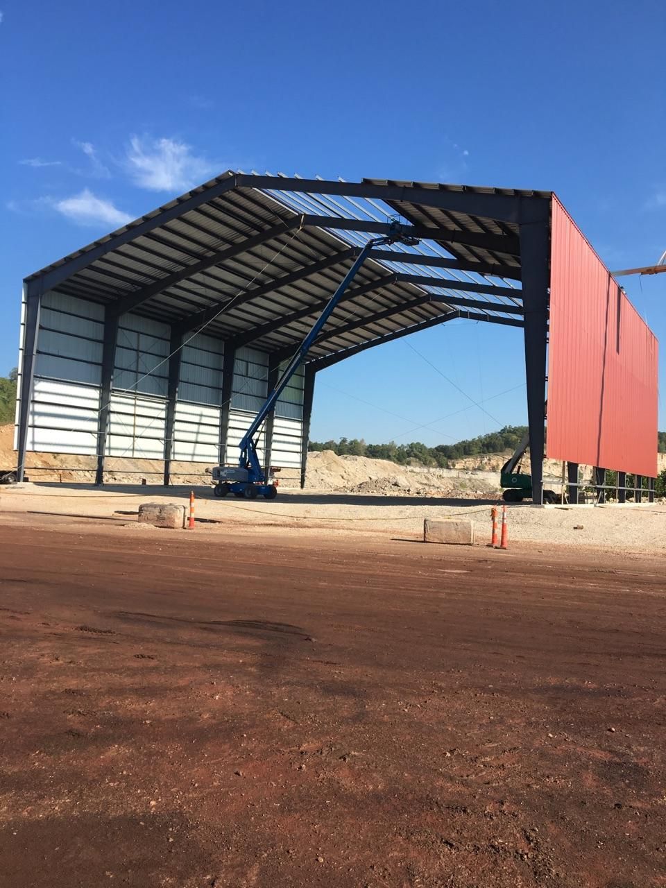 A large building under construction with a red roof