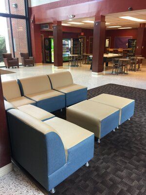 A living room with a lot of furniture and tables.