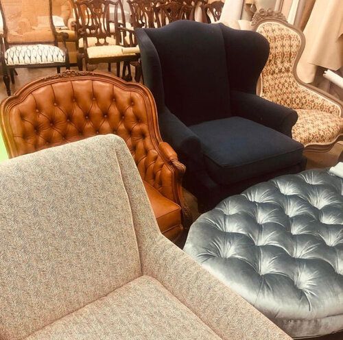 A group of chairs and ottomans in a room