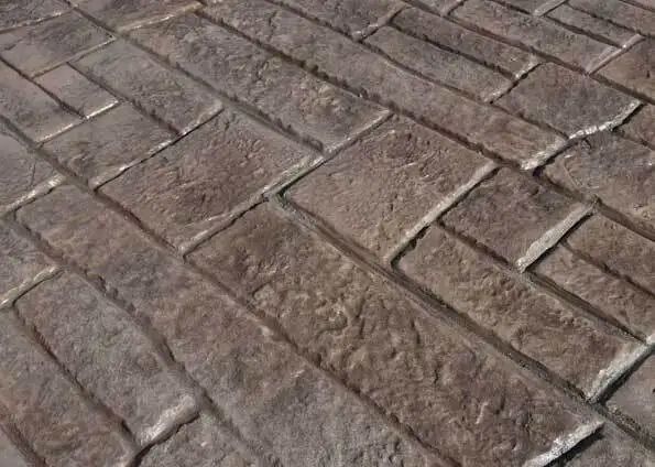 A close up of a brick pavement with a brick pattern.