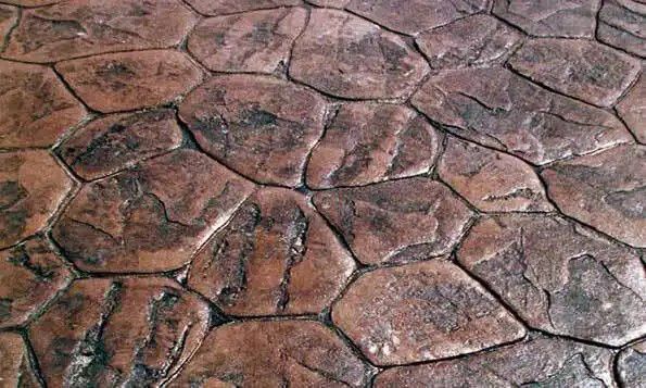 A close up of a stone floor with a pattern of rocks.