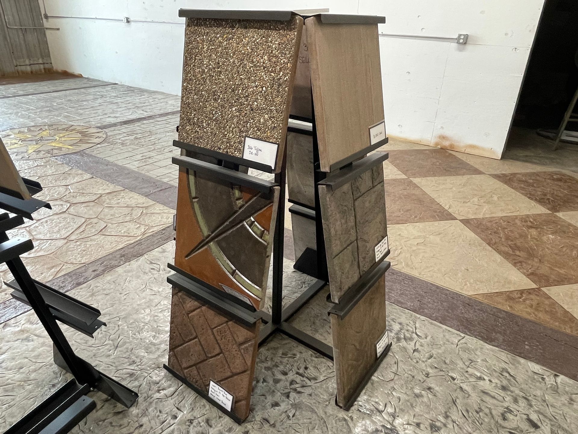 A display of tiles is sitting on a tiled floor.