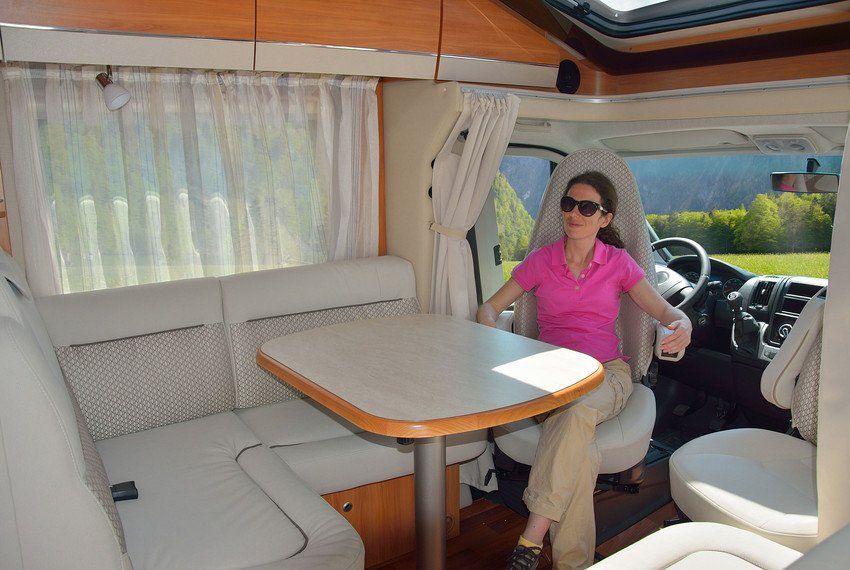 woman seating inside the RV