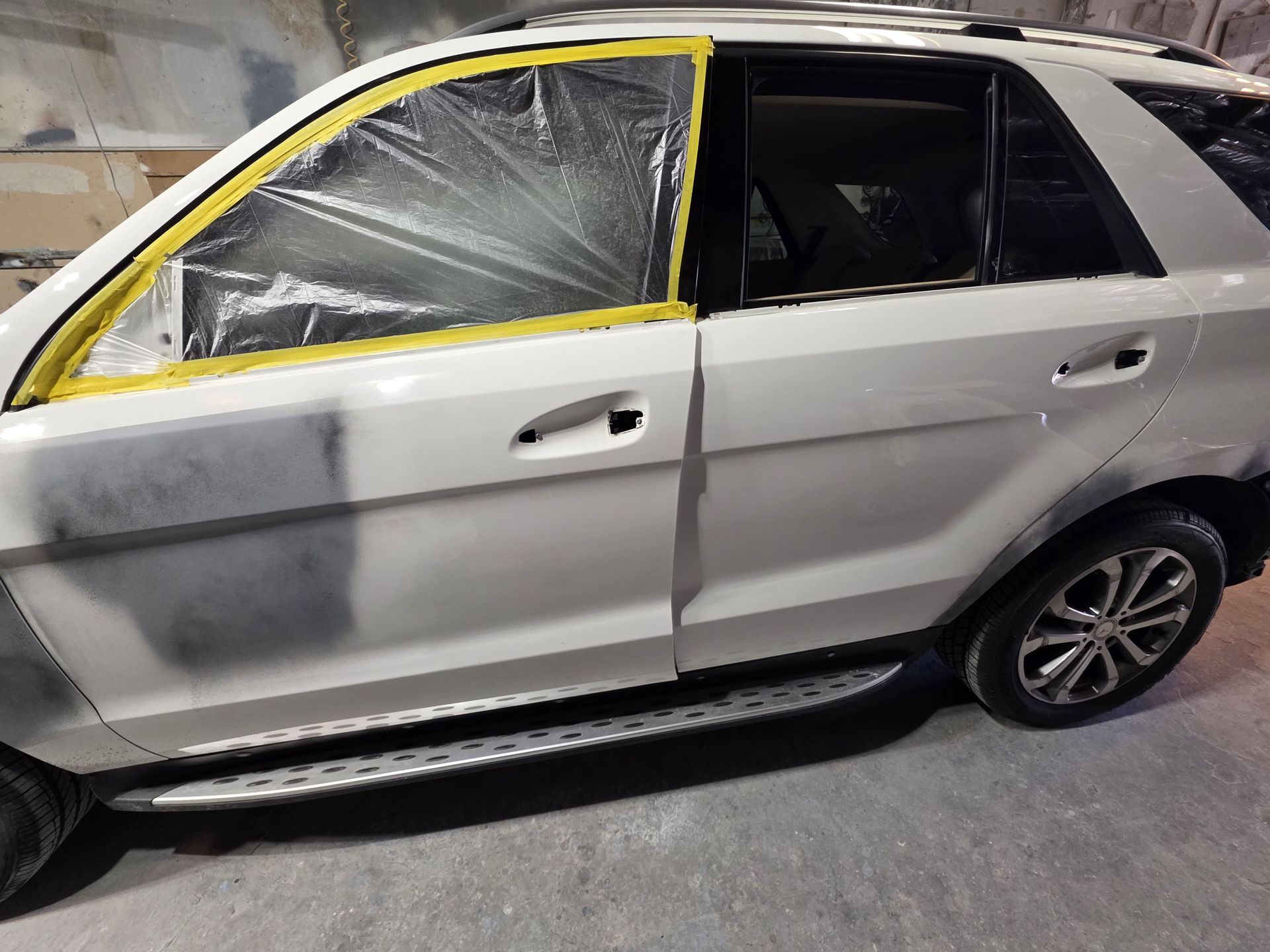 White SUV with shattered front side window and yellow taped outline