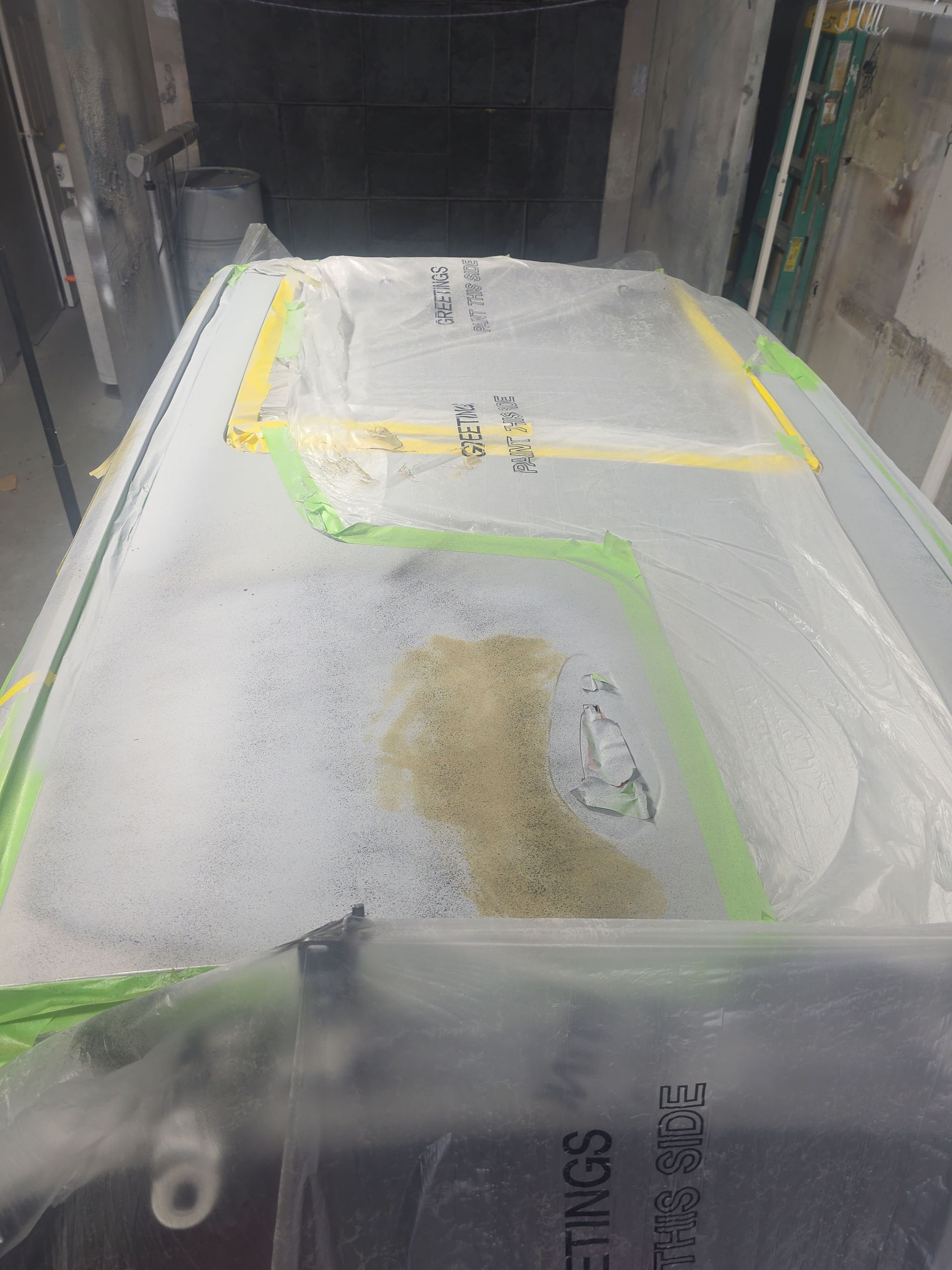 White powder-covered cargo pallet on a truck bed, marked with yellow tape and labels